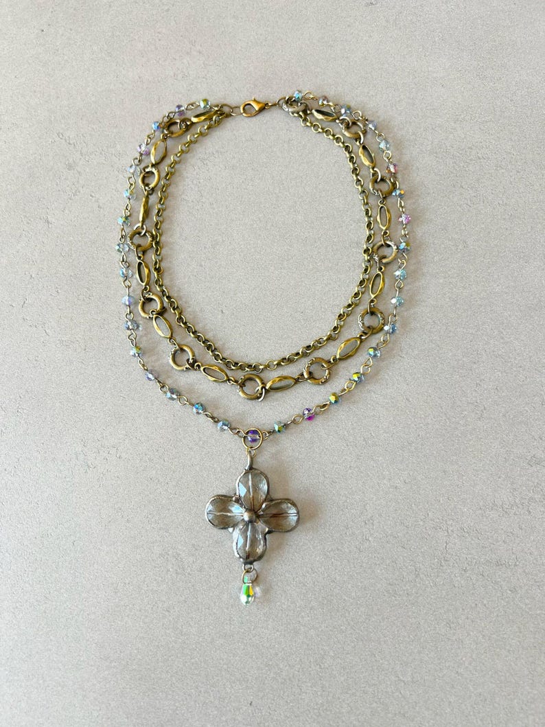 Layered necklace with clear glass crystal pendants.