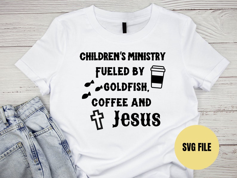 May include: White t-shirt with black text that reads "Children's Ministry Fueled by Goldfish, Coffee and Jesus" with a cross and a coffee cup graphic.