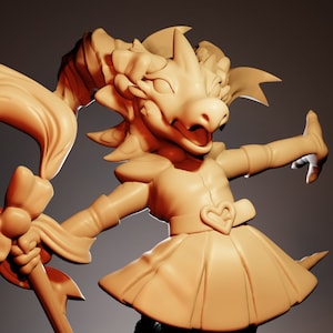 May include: A tan-colored figurine of a dragon-like creature in a dress, holding a staff with a large bow. The creature has a heart-shaped detail on its dress and is posed with one leg raised. The background is a gradient of brown.