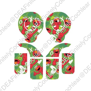 May include: Four green and red patterned stickers featuring Elmo from Sesame Street. The stickers are designed to fit on a cochlear implant.