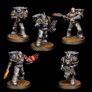 May include: Five miniature figurines of armored warriors. Each figure is painted in shades of gray and black with gold accents. The warriors are posed on small, circular bases, and some are holding weapons with red and orange highlights.