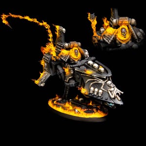 May include: A miniature figurine of a warrior riding a black vehicle, engulfed in flames. The warrior wears a skull-shaped helmet and is surrounded by orange and yellow fire. The vehicle is adorned with skulls and skeletal designs.