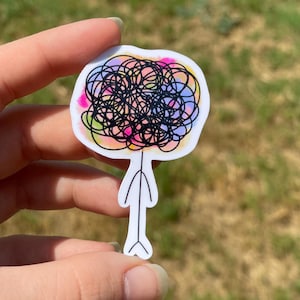 May include: A colorful sticker with a black and white doodle of a person with a large head. The head is filled with colorful swirls and lines.