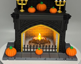 May include: A black decorative fireplace with a lit candle, pumpkins, and gold candle holders. The fireplace has a brick interior and a decorative grate. Orange pumpkins with green stems are placed on the mantel and base.
