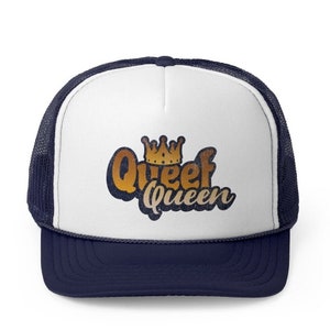 May include: A white and navy blue trucker hat with a gold crown and the text "Queef Queen" in a vintage style font.