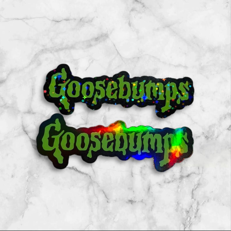 May include: Two die-cut stickers featuring the word Goosebumps in a stylized green font. The top sticker has a holographic finish with small star-shaped sparkles, while the bottom sticker displays a smooth, vibrant rainbow holographic effect.