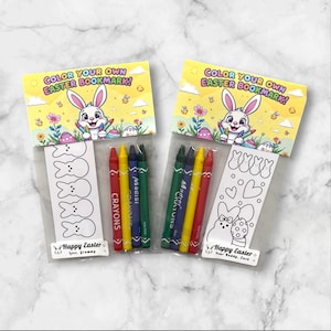 May include: Two clear plastic bags with a color your own Easter bookmark inside. Each bag contains a coloring page with a bunny and a set of crayons. The bags have a yellow and white background with a bunny and the text "Color Your Own Easter Bookmark!"
