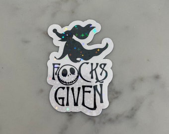 May include: A white sticker with a black silhouette of Jack Skellington from The Nightmare Before Christmas. The text "F*cks Given" is written below the silhouette.