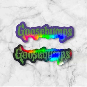 May include: Two die-cut stickers featuring the word Goosebumps in a stylized green font. The top sticker has a vibrant rainbow gradient background with a purple border. The bottom sticker features a holographic finish with a black border.