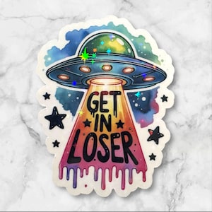 May include: A sticker featuring a UFO with the text "GET IN LOSER." The UFO is blue with a green dome and a bright light beam. The text is in a dripping style, with a colorful background and star accents.