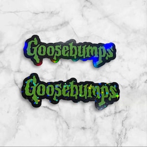 May include: Two die-cut stickers featuring the word Goosebumps written in a stylized, dripping green font. The stickers have a dark, holographic background that reflects light with small, colorful star-shaped sparkles across the surface.