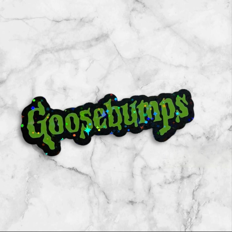 May include: A die-cut sticker featuring the word Goosebumps in a stylized, jagged green font with a black outline. The surface of the green lettering has a holographic finish that reflects small, multicolored star-shaped light patterns.