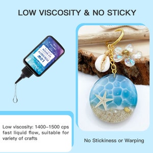 May include: A bottle of low viscosity UV resin with the text "LOW VISCOSITY UV RESIN" and a keychain with a blue and white resin charm featuring a starfish and seashells. The text "LOW VISCOSITY & NO STICKY" is at the top of the image. The text "Low viscosity: 1400-1500 cps fast liquid flow, suitable for variety of crafts" is at the bottom left of the image. The text "No Stickiness or Warping" is at the bottom right of the image.