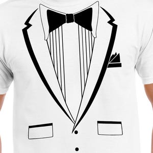 May include: White t-shirt featuring a black tuxedo design. The graphic includes a bow tie, lapels, a pocket square, and buttons. This novelty tee is a fun and easy costume option for parties or events.