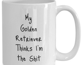 May include: White ceramic mug with a curved handle. The mug features black text that reads "My Golden Retriever Thinks I'm the Shit". A humorous gift for dog lovers.