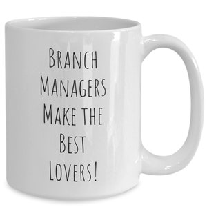May include: White ceramic mug with a curved handle. The mug features black text that reads "BRANCH MANAGERS MAKE THE BEST LOVERS!" The mug is designed for hot beverages and is suitable for home or office use.