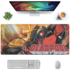 May include: A red and black Deadpool mousepad with a comic book style illustration of Deadpool holding a gun. The text "DEADPOOL" is printed in red letters on the mousepad.