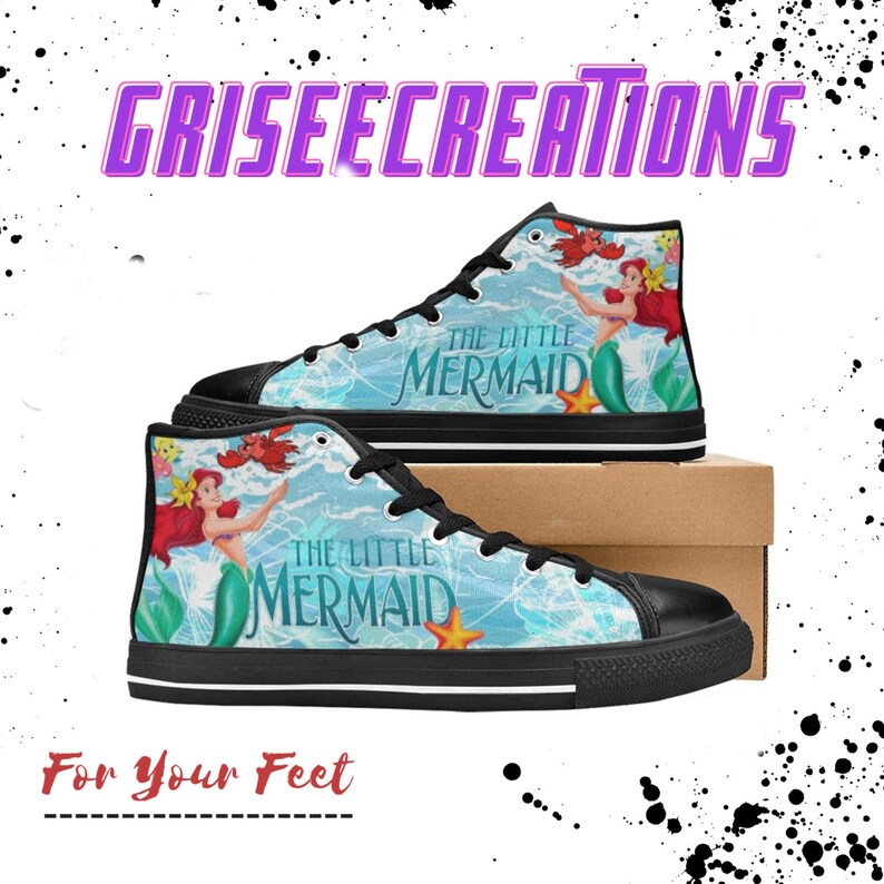 May include: High-top canvas sneakers featuring a design from "The Little Mermaid" with Ariel, Flounder, and Sebastian. The shoes have a black toe cap and sole, with the text "The Little Mermaid" on the side. The brand name "Griseecreations" is at the top.