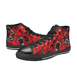 May include: High-top canvas shoes with a black sole and red and black print featuring a superhero character.