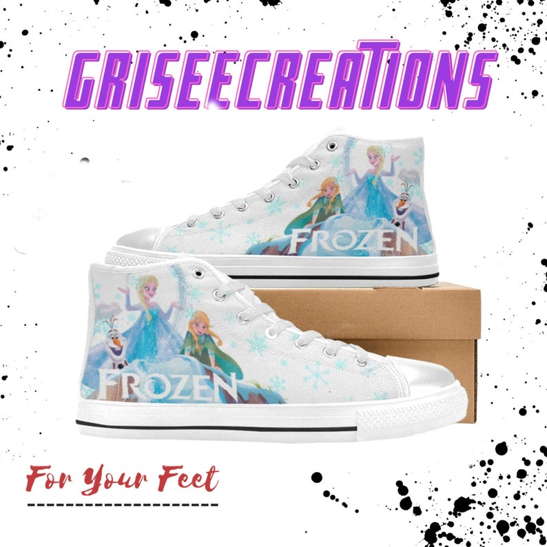 May include: White high-top canvas shoes with a Frozen theme. The shoes feature images of Elsa, Anna, and Olaf from the Disney movie Frozen. The shoes have a white background with blue snowflakes and the word "Frozen" printed in blue.