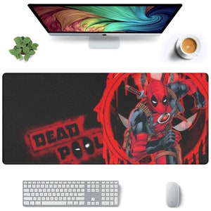 May include: A black and red mousepad with a graphic of Deadpool, a superhero, running with a sword. The text "DEAD POOL" is written in red on the mousepad.