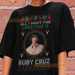 May include: Black t-shirt with a Christmas-themed design featuring a photo of Ruby Cruz and the text "All I want for Christmas is Ruby Cruz".