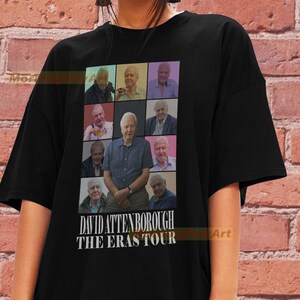 May include: Black t-shirt featuring a collage of images of David Attenborough throughout his career. The text "David Attenborough The Eras Tour" is printed below the images.