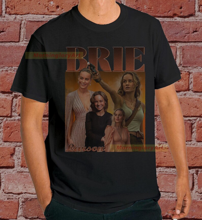 May include: Black t-shirt with a collage of images of Brie Larson. The text "BRIE LARSON" is printed in large, bold letters across the top of the image.