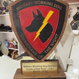 May include: A white ceramic mug with a black handle and the text "But First, Coffee" in a bold, black font. The mug is set against a neutral background, highlighting its simple design.