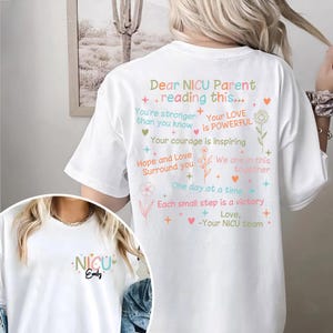 May include: White t-shirt with a message of encouragement for NICU parents. The text reads "Dear NICU Parent reading this... You're stronger than you know Your LOVE is POWERFUL Your courage is inspiring Hope and Love Surround you We are in this together One day at a time Each small step is a victory Love, -Your NICU team".