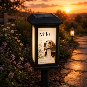 May include: A black solar-powered garden lantern featuring a rectangular illuminated panel with a portrait of a beagle dog. The text reads "FOREVER BY MY SIDE", "Milo", and "2012 - 2026", accompanied by floral illustrations and small paw prints.