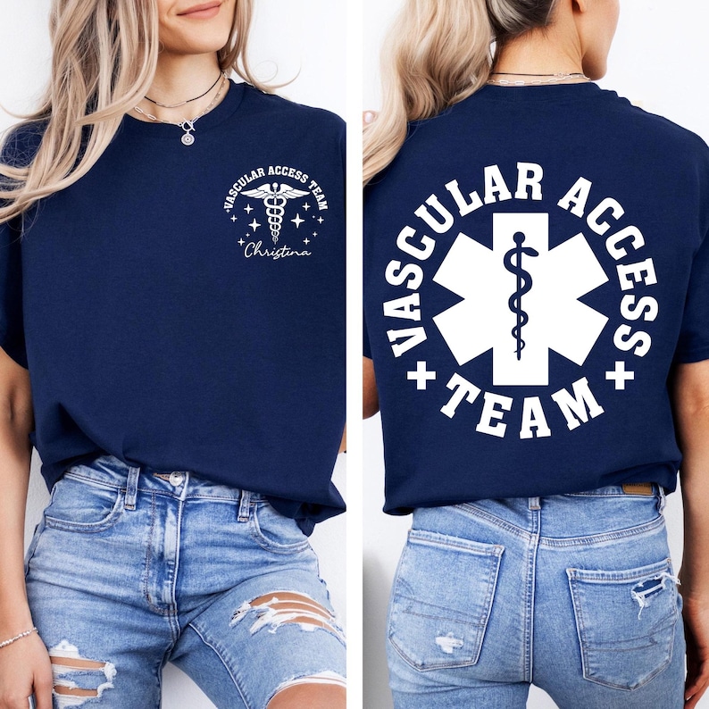 May include: Navy blue t-shirt with white text and graphics. The front features a caduceus symbol and the words "Vascular Access Team" and a name. The back displays a large white emblem with the words "Vascular Access Team".