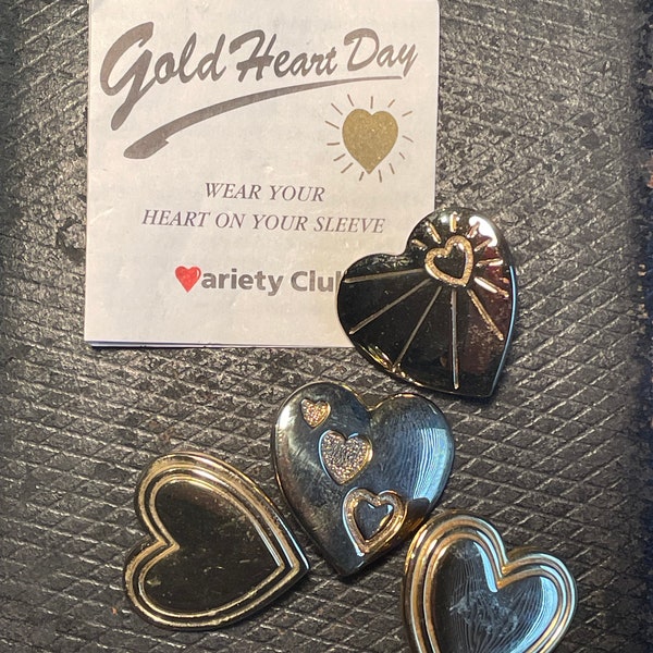 Four Variety Club Gold Heart Day badges