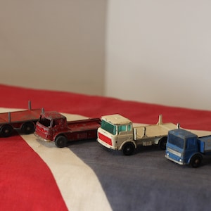 Four Diecast Metal Matchbox Lesney and Husky Toy Trucks From The 1960&#39;s