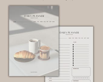 May include: A printable daily planner with a simple design. The planner has sections for to-do lists, priorities, and reminders. The image shows a version of the planner with a coffee and pastry illustration.