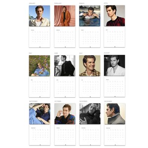 May include: A twelve-month wall calendar featuring a collection of twelve distinct photographs of actor Andrew Garfield, with each month labeled from January to December above a grid of dates for the year, printed on white paper with black text.