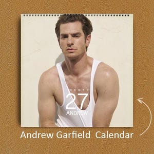 May include: A wall calendar featuring a portrait of Andrew Garfield wearing a white tank top. The calendar cover displays the text TWENTY 27 ANDREW in white lettering. The calendar is spiral bound at the top and includes the text Andrew Garfield Calendar.