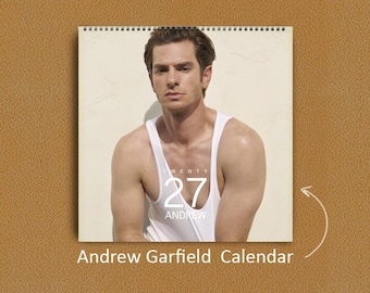 May include: A wall calendar featuring a portrait of Andrew Garfield wearing a white tank top. The calendar cover displays the text TWENTY 27 ANDREW in white lettering. The calendar is spiral bound at the top and includes the text Andrew Garfield Calendar.