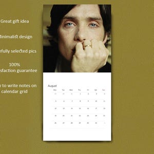 May include: A wall calendar featuring a portrait of a person with dark hair and blue eyes resting their chin on a hand with a ring. The calendar page displays the month of August with a grid of dates and the text Great gift idea, Minimalist design, Carefully selected pics, 100% Satisfaction guarantee, and Easy to write notes on calendar grid.