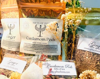 May include: A selection of dried herbs and spices in clear and gold foil pouches, labelled "Gifts of Isis". The image includes "Ginger" and "Cardamom Pods". A clear crystal and dried flowers are also visible.