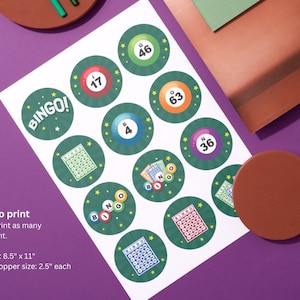 May include: Printable bingo card cupcake toppers with green, yellow, and blue colors. The cards feature numbers 17, 46, 4, 63, and 36. The text "BINGO!" is on one of the cards. The text "Ready to print" is at the bottom of the page. The text "You can print as many as you want." is below the text "Ready to print". The text "Paper size: 8.5" x 11" is below the text "You can print as many as you want.". The text "Cupcake topper size: 2.5" each" is below the text "Paper size: 8.5" x 11".