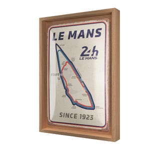 Könnte beinhalten: Gerahmtes Schild im Vintage-Stil der Rennstrecke Le Mans 24h. Das Schild zeigt eine Karte der Strecke in Rot und Blau mit dem Text "LE MANS 24h LE MANS" und "SINCE 1923". Das Schild ist in einem hellbraunen Holzrahmen eingefasst.