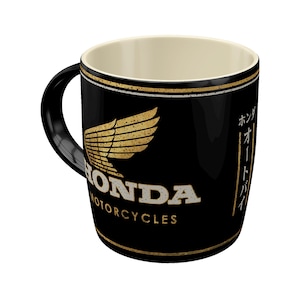Tasse mit Henkel, schräg von vorn und vollständig auf weißem Hintergrund. Das Motiv zeigt „Honda MC - Motorcycles Gold“.