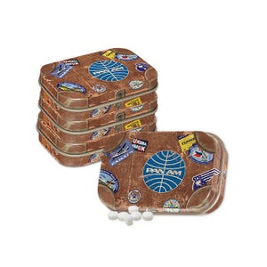 May include: A stack of four vintage-style metal tins with a brown leather suitcase design. The tins feature the Pan Am logo and various travel stickers. The top tin is open, revealing a small pile of white mints.