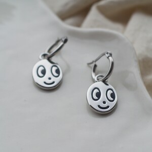 Abstract face, Emoji pendant hoop earrings in Silver tone.