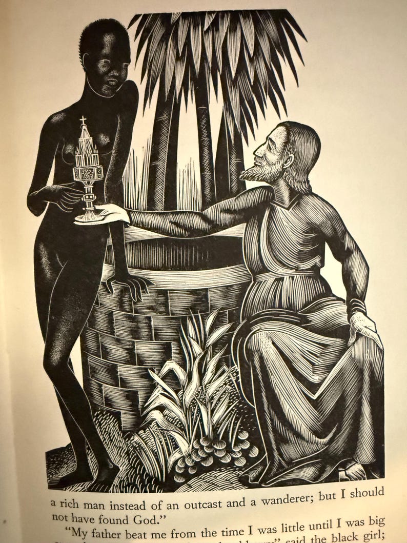 May include: A white ceramic mug with a black handle and the text "But First, Coffee" in a black, bold font. The mug is on a white surface. The mug is approximately 10 cm tall.