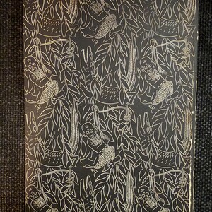 May include: A black and white illustrated book cover with a jungle theme. The design features monkeys, crocodiles, and leaves. The monkeys have long beards and are swinging from vines. The background is black, and the illustrations are white.