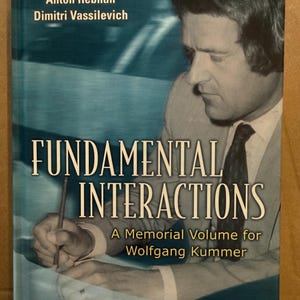 May include: A book titled "Fundamental Interactions" with a blue and white cover. The cover features a black and white photo of a man and the text "A Memorial Volume for Wolfgang Kummer." Published by World Scientific.