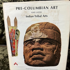 May include: Book cover with the title "Pre-Columbian Art and Later Indian Tribal Arts" with a brown stone sculpture of a face on the front cover.