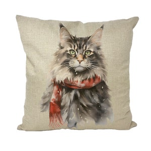 May include: A watercolor illustration of a gray and white cat wearing a red scarf on a beige linen pillow cover.